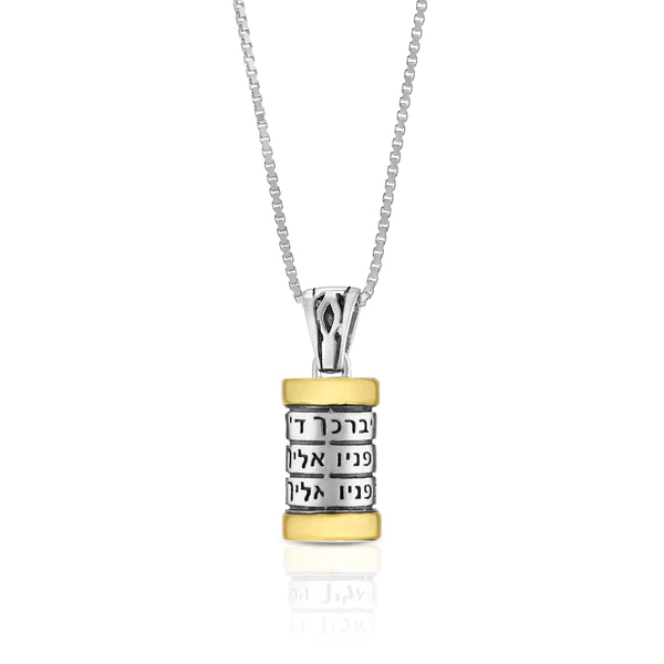 A silver pendant in the shape of a cylinder featuring the Priestly Blessing, crafted in a combination of silver and gold.