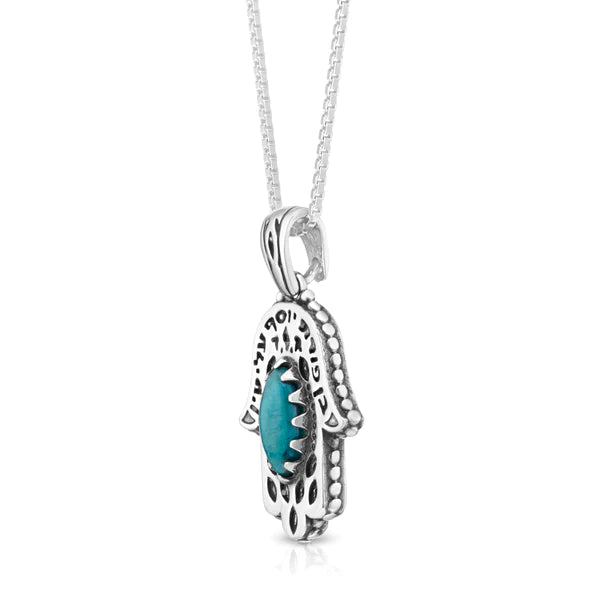 A silver Hamsa pendant with a turquoise stone.