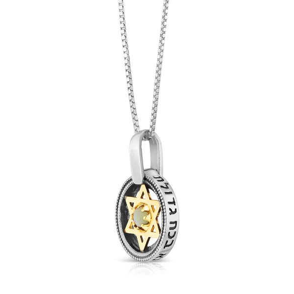 A silver pendant with a gold Star of David embedded with a cat's eye stone.