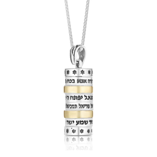 A cylindrical silver pendant with a combination of gold, featuring the Four Blessings.