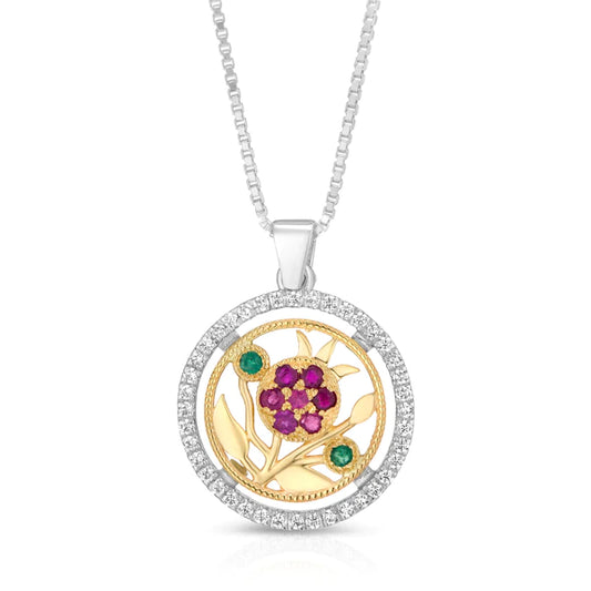 A silver pendant with pomegranate motifs embedded in a combination of silver and gold.