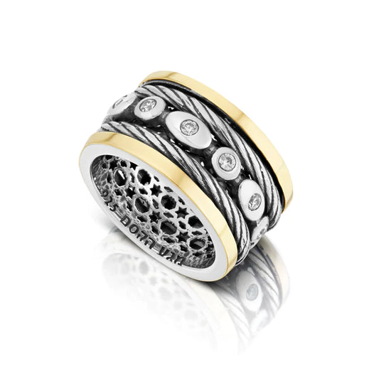 A sterling silver ring with a rotating design, featuring white cubic zirconia accents.