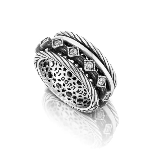 A rotating silver ring with cubic zirconia accents.