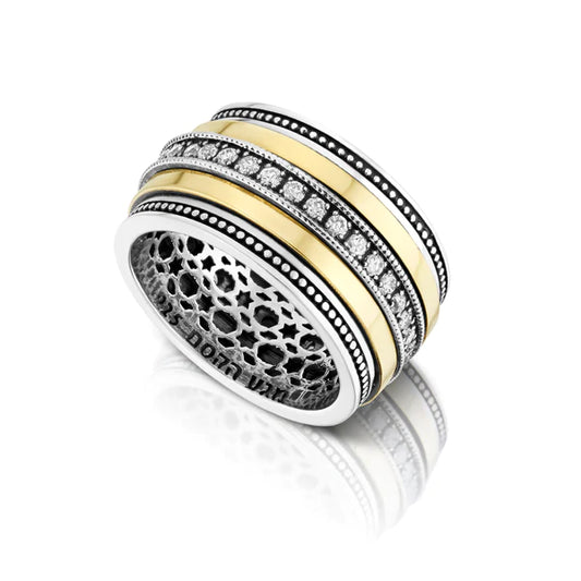 A silver ring with a combination of gold and white zircon gemstone accents.