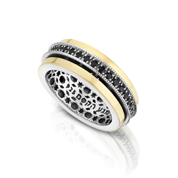 A rotating ring with onyx gemstones set in silver and gold.