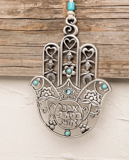 A stunning Hamsa wall hanging embellished with turquoise.