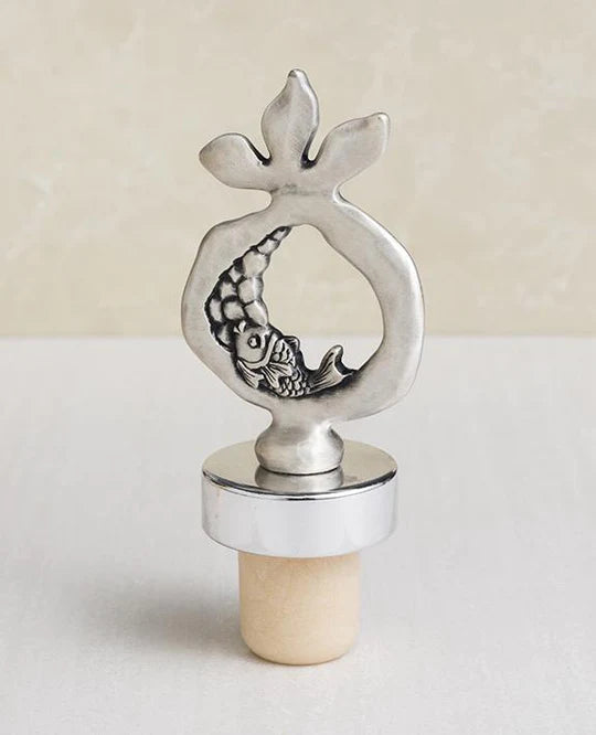 A beautiful pomegranate-shaped wine stopper, coated in silver.