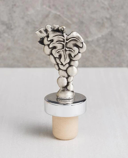 A magnificent wine stopper adorned with a cluster of grapes, coated with a silver plating.