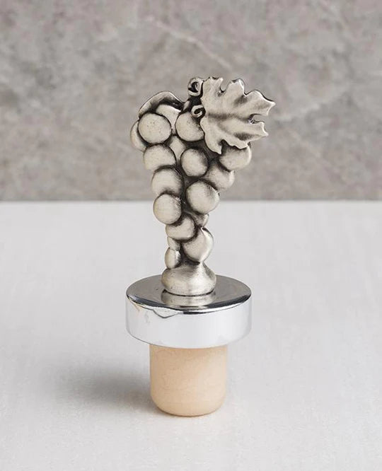 A magnificent wine stopper adorned with a cluster of grapes, coated with a silver plating.