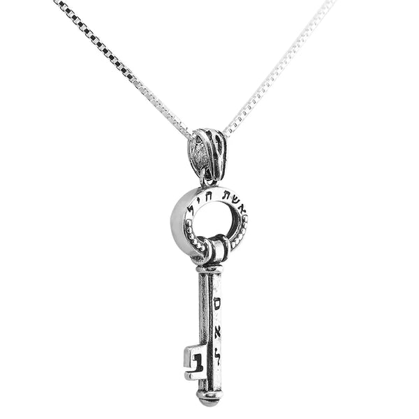 A silver key-shaped pendant with the inscription "Eshet Chayil" (Woman of Valor).